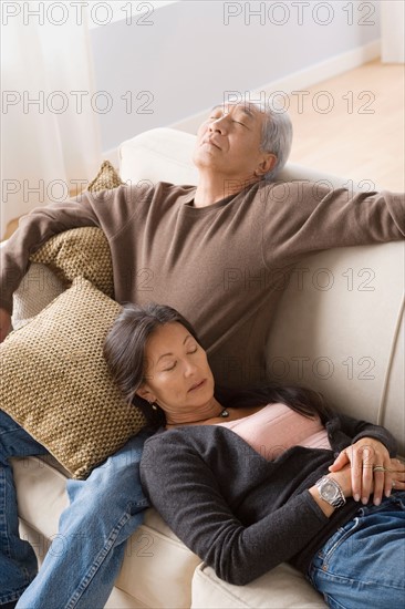 Portrait of couple resting on sofa. Photo : Rob Lewine