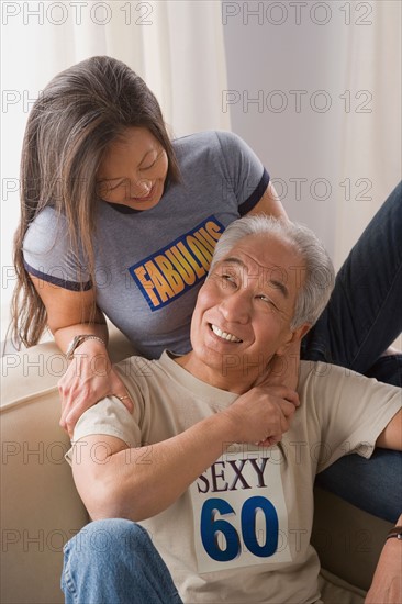 Older couple holding hands and laughing. Photo : Rob Lewine