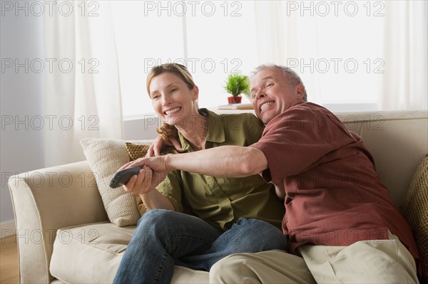 Couple fighting for tv remote. Photo : Rob Lewine