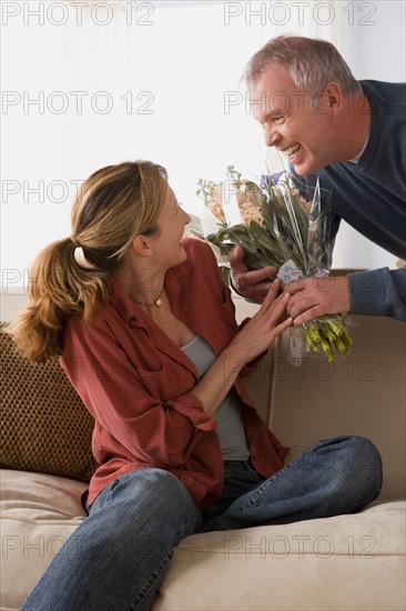 Man giving flowers to wife. Photo : Rob Lewine