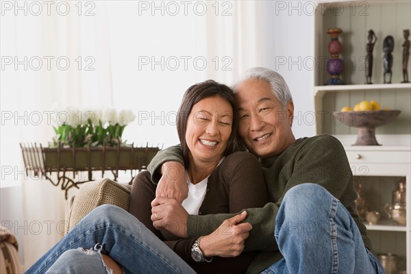 Older couple in warm embrace. Photo : Rob Lewine