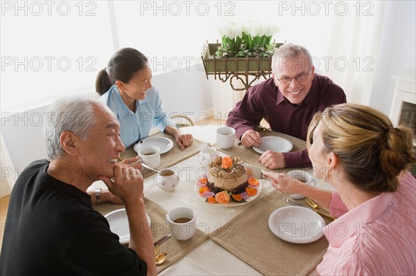 Two couples having coffee with cake. Photo : Rob Lewine