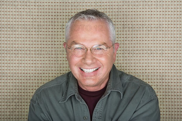 Studio portrait of senior man smiling. Photo : Rob Lewine