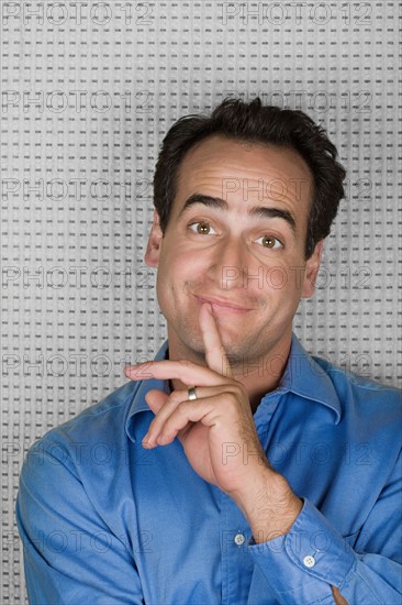 Studio portrait of mid adult man smiling. Photo : Rob Lewine