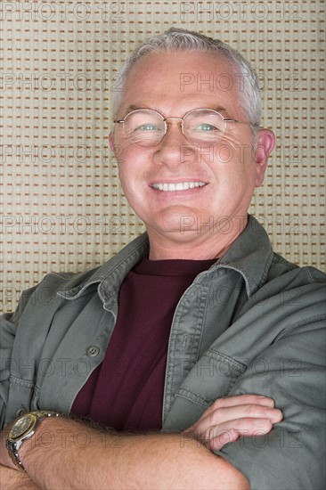 Studio portrait of senior man smiling. Photo : Rob Lewine