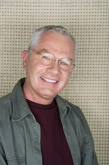 Studio portrait of senior man smiling. Photo : Rob Lewine