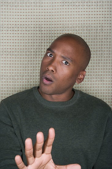 Studio portrait of mid adult man gesturing. Photo : Rob Lewine