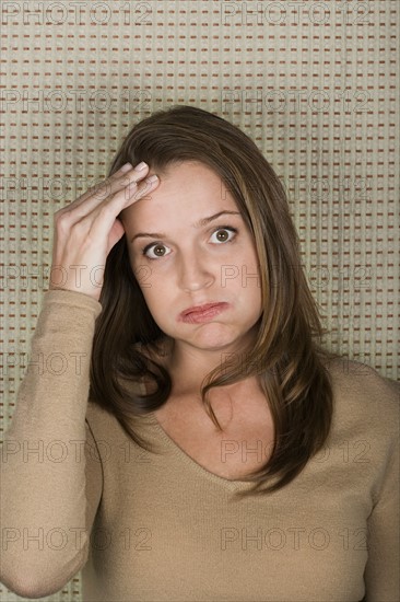 Studio portrait of mature woman pouting. Photo : Rob Lewine