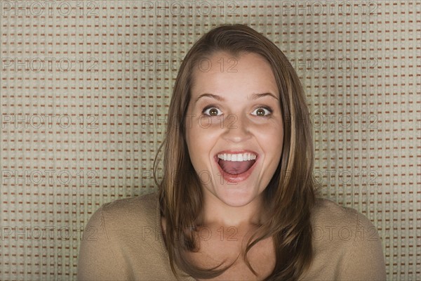 Studio portrait of mature woman laughing. Photo : Rob Lewine