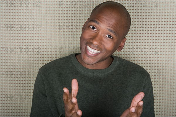 Studio portrait of mid adult man smiling. Photo : Rob Lewine