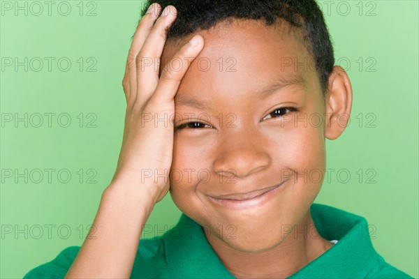 Studio portrait of teenage boy smiling. Photo : Rob Lewine