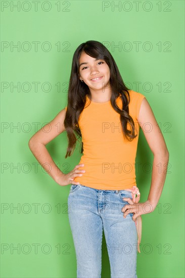 Studio portrait of teenage (16-17) girl smiling. Photo : Rob Lewine