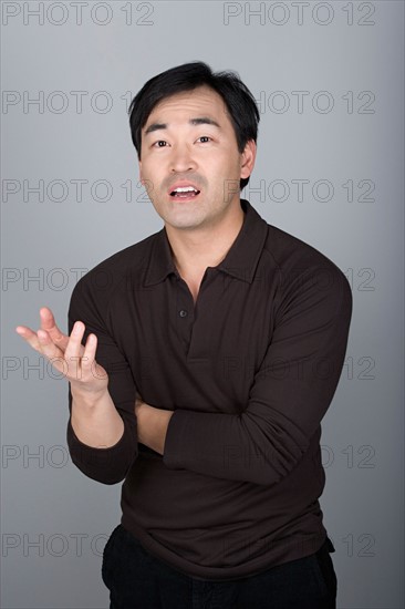 Studio shot portrait of mature man gesturing, waist up. Photo : Rob Lewine