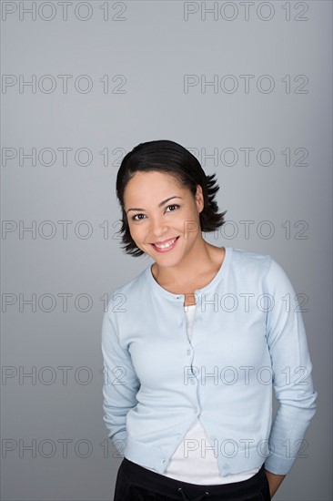 Studio shot portrait of smiling mid adult woman, waist up. Photo : Rob Lewine