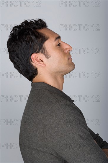Side view of mid adult man with hands on hip, head and shoulders. Photo : Rob Lewine