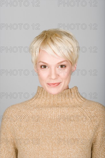 Studio shot portrait of mid adult woman, head and shoulders. Photo : Rob Lewine