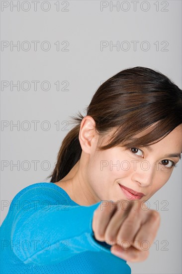 Studio portrait of playful Asian woman. Photo : Rob Lewine