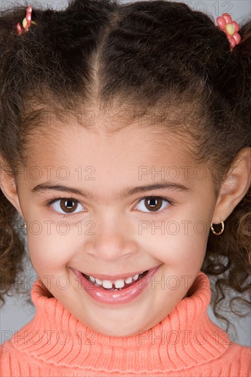 Studio portrait of happy pre-teen girl (10-11). Photo : Rob Lewine