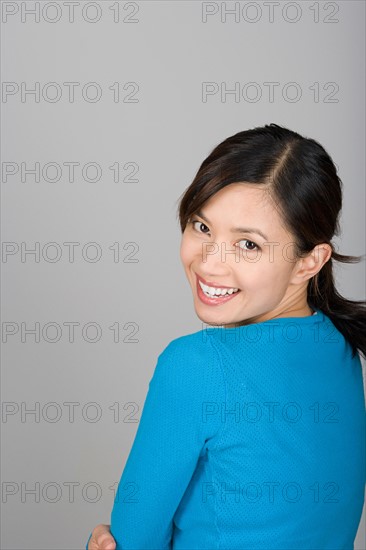 Studio portrait of happy Vietnamese woman. Photo : Rob Lewine