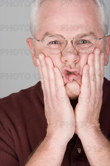 Studio portrait of worried senior man. Photo : Rob Lewine