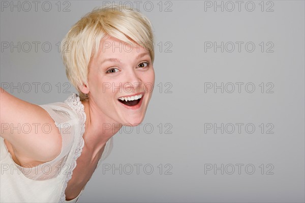 Studio portrait of playful young woman. Photo : Rob Lewine