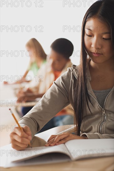 School kid writing in their copybooks. Photo : Rob Lewine