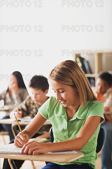 School kid writing in their copybooks. Photo : Rob Lewine
