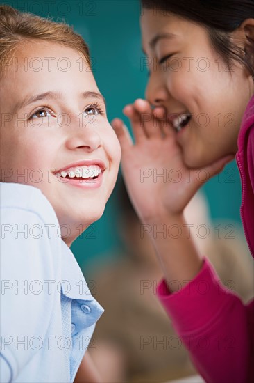 Two girls gossiping. Photo : Rob Lewine