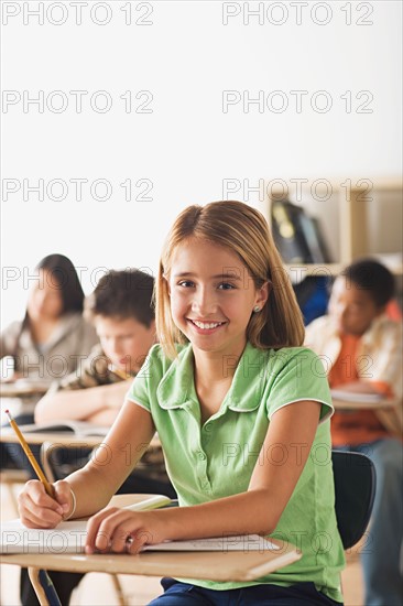 Class writing in their copy books. Photo : Rob Lewine