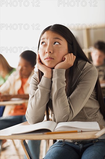 Bored girl sitting in classroom. Photo : Rob Lewine