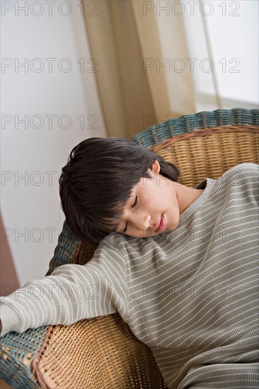 Young man sleeping on armchair. Photo : Rob Lewine