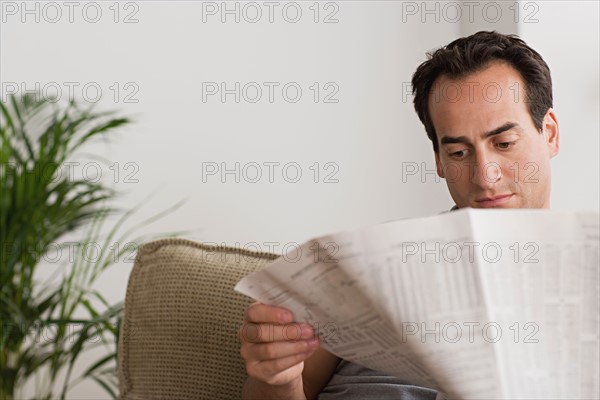 Man reading newspaper. Photo : Rob Lewine