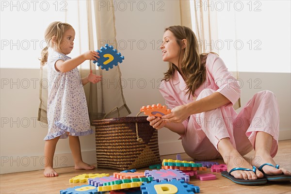 Mother playing with daughter. Photo : Rob Lewine