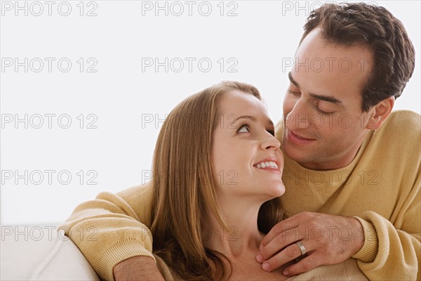 Married couple in close embrace looking at each other. Photo : Rob Lewine