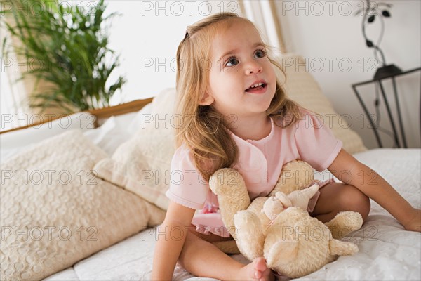 Girl with teddy bear. Photo : Rob Lewine