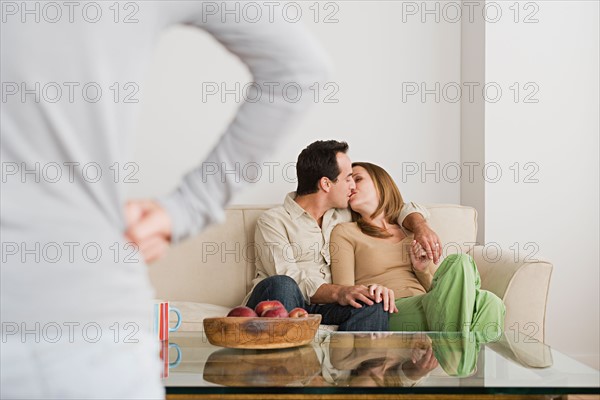 Couple kissing on sofa. Photo : Rob Lewine