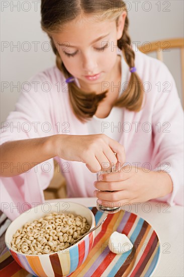 Girl (12-13) eating breakfast. Photo : Rob Lewine