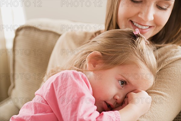 Girl (8-9) in mother's arms. Photo : Rob Lewine
