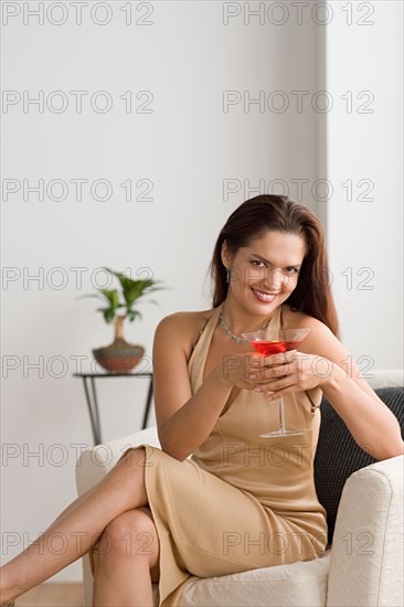 Portrait of smiling woman with cocktail. Photo : Rob Lewine