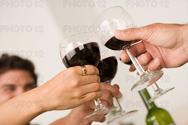 Hands holding wineglasses during toast . Photo : Rob Lewine