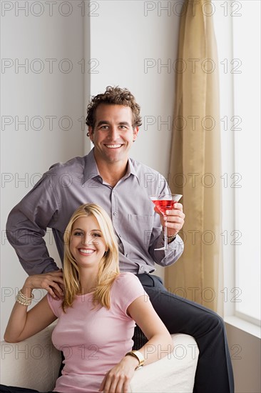 Portrait of smiling couple at home party. Photo : Rob Lewine