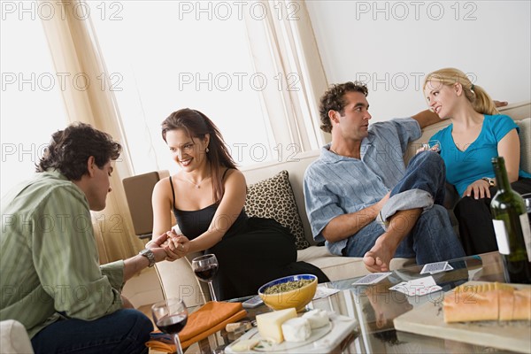 Couples on sofa at home party. Photo : Rob Lewine