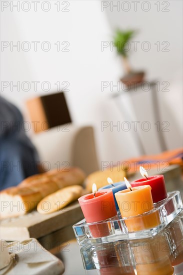 Burning candles on table. Photo : Rob Lewine