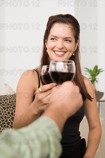 Smiling woman toasting. Photo : Rob Lewine