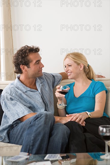 Happy couple sitting on sofa. Photo : Rob Lewine