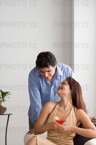 Happy couple together, woman holding cocktail. Photo : Rob Lewine