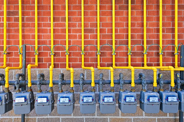 Gas meters against brick wall. Photo :  Elena Elisseeva