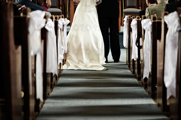 Low section of bride and groom in church. Photo :  Elena Elisseeva