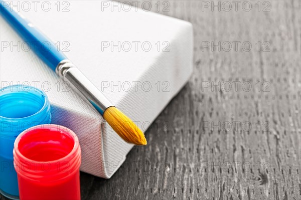 Studio shot of paintbrush, paints and canvas. Photo : Elena Elisseeva