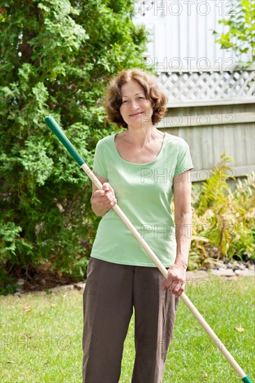 Woman working in backyard garden. Photo : Elena Elisseeva